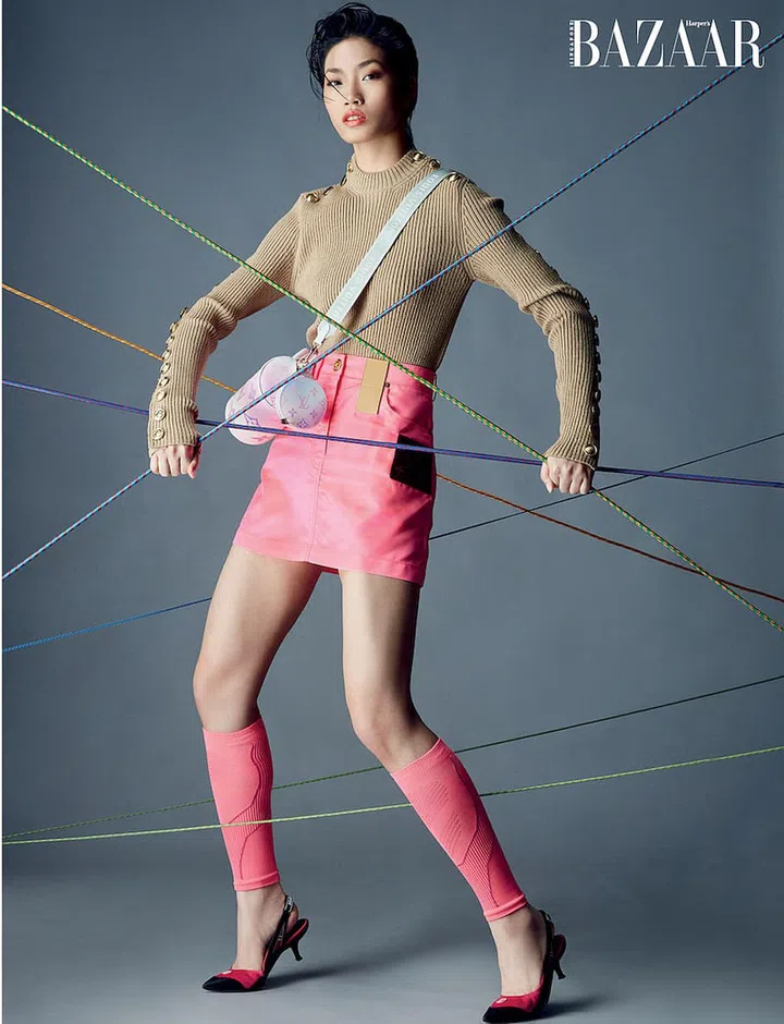 Wool‐blend pullover; cotton‐blend miniskirt; coated canvas Papillon BB Degrade bag; leather Archlight slingbacks, all from Louis Vuitton. Leg warmers, stylist’s own. (Photo: Gan)