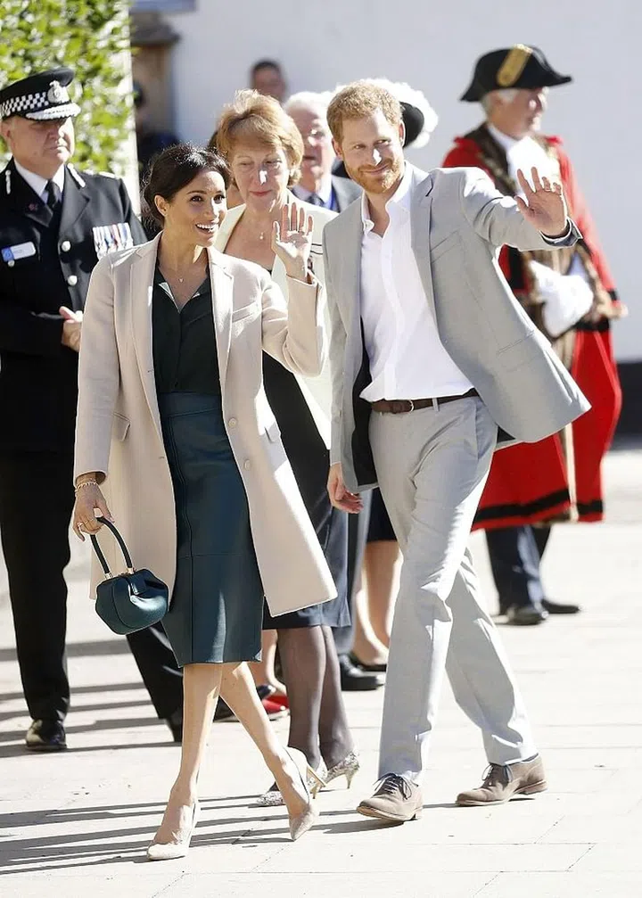 The pair smiled and waved in the sunshine.