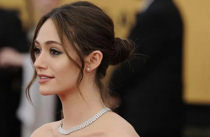 By leaving wisps of hair in front of the face, this low bun offers a less-severe alternative to a slicked back style. Photo: Getty 