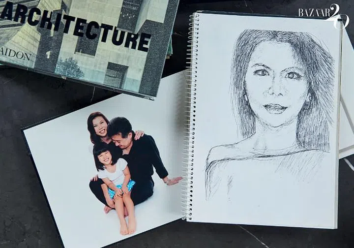 A family portrait next to a portrait of Chuah sketched by Tan. 

Photo: Phyllicia Wang