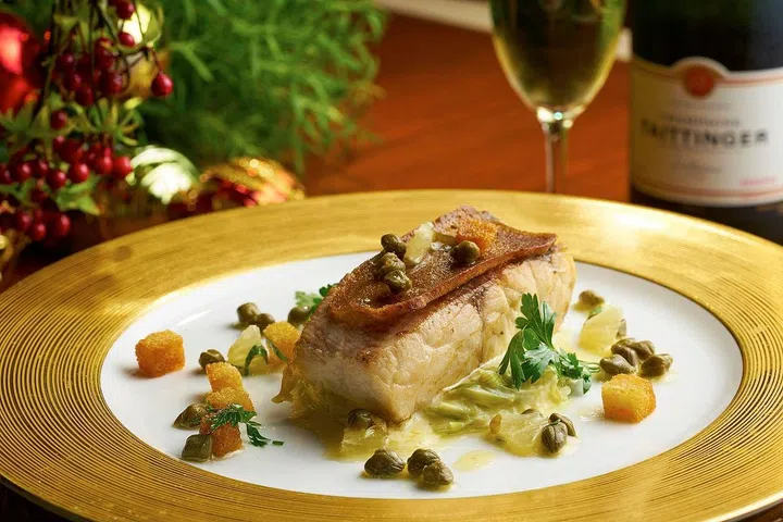 Roasted Barramundi with Gingerbread crust, Yuzu Grenobloise and Leek compote