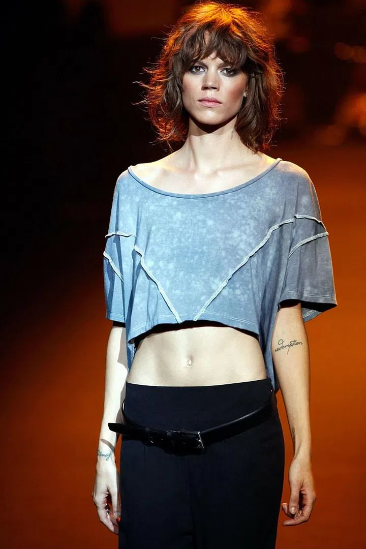 The model has a number of tattoos, from "redemption" on her left forearm to "float" scrawled on the left side of her neck.