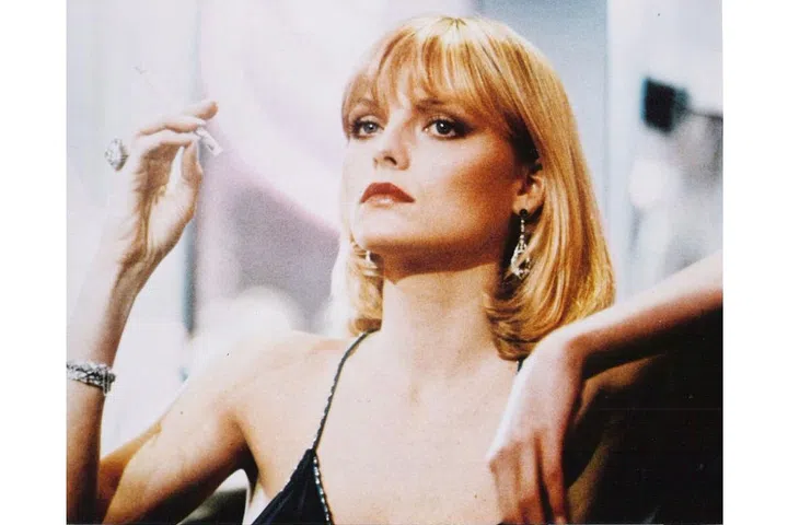 The ultimate bad-girl style and beauty icon: Michelle Pfeiffer as Elvira Hancock in the 1983 film Scarface. Her haircut is iconic: a sleek bob with bangs and flipped ends.