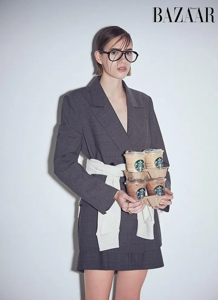 Blazer; matching skirt, Brunello Cucinelli. Sweater, CELINE. Glasses, Ray-Ban. Rings, Bottega Veneta