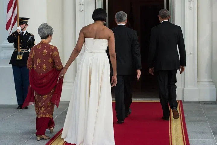The back of the skirt beautifully draped behind the First Lady, separate from the fitted body of the dress in the front.