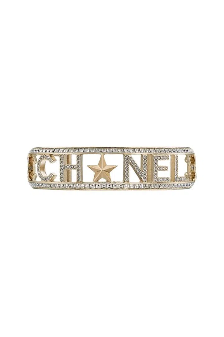 Add a bit of vintage glamour to your outfit with Chanel's metal star bracelet. 