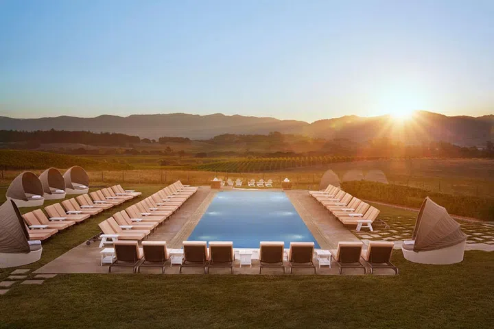 Napa's Carneros Resort and Spa, formerly known as  the Carneros Inn, is surrounded by 28 acres of grapevines, fruit trees, and picturesque farmland. The charming luxury resort has 86 cottages, 10 suites, and private homes clustered throughout the property. The adults-only Hilltop Pool provides guests with the quintessential Napa Valley experience. "The Hilltop Pool is our best-kept secret as it is tucked away from the buzz of Sonoma Highway and provides a tranquil adult-only setting," says the owner, Greg Flynn. "It's a front-row seat to incomparable views." 