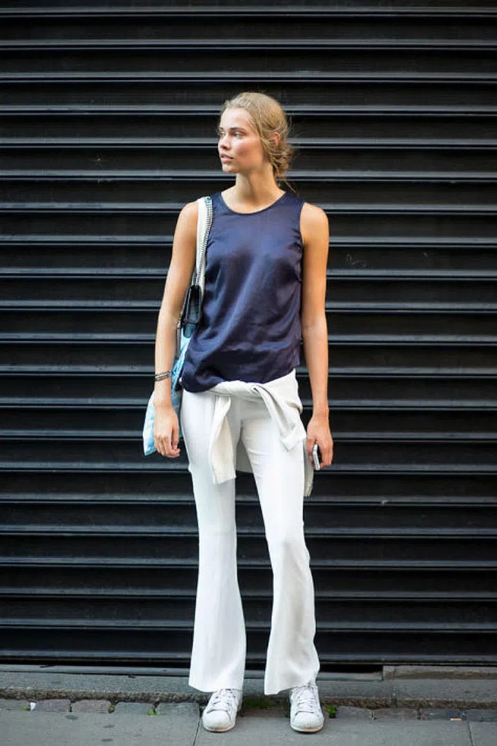 Keep things simple with a pair of white flared jeans and basic tank top.Photo: Diego Zuko 