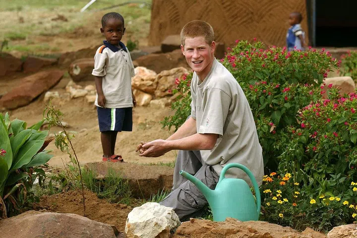 Prince Harry, 19, with a young orphan at the Mants'ase Children's Home in southern Africa.