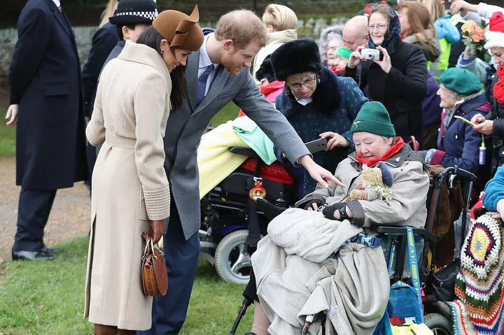 Meghan and Harry stopped to meet those who had gathered to wish the royal family a Merry Christmas.