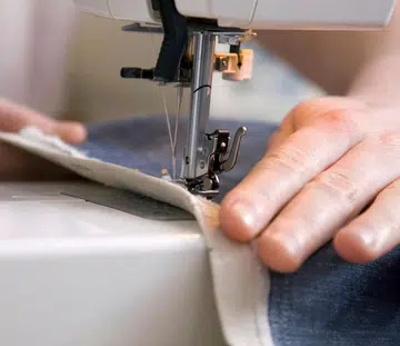 Close up of hands using a sewing machine