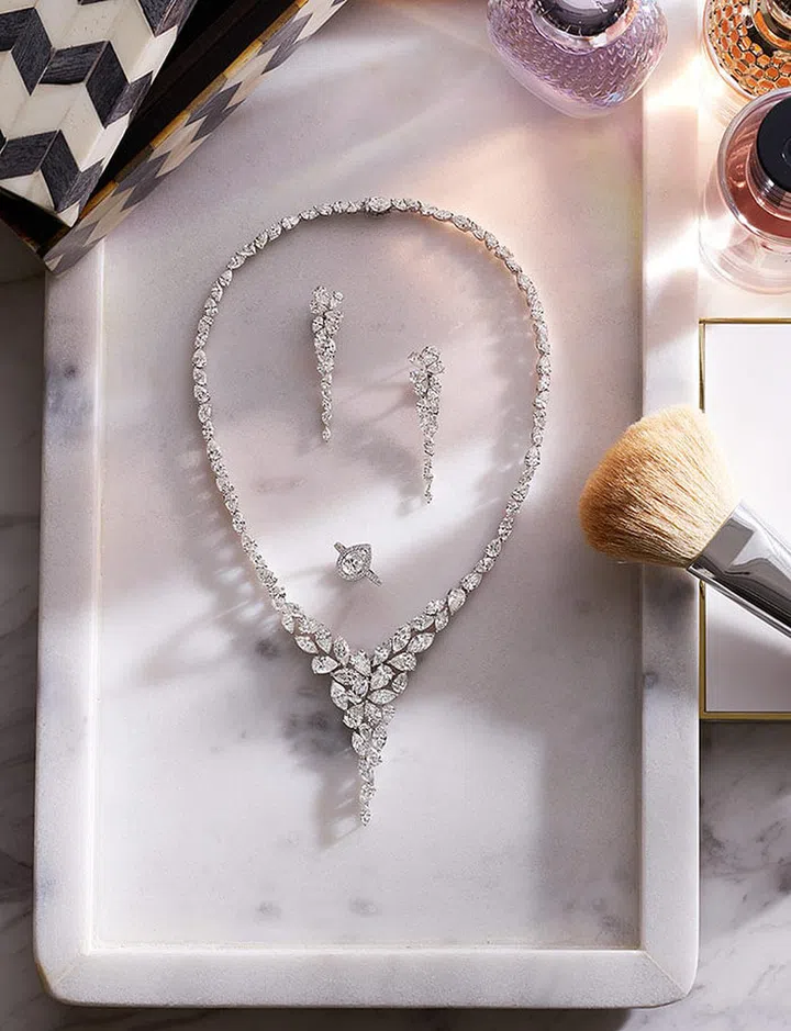 From top: GRAFF Foliage Collection pear-shaped and marquise-cut diamond necklace (45.59 carats); pear-shaped and marquise-cut diamond earrings (8.28 carats); GRAFF Constellation ring with 1.51-carat carat pear-shaped diamond.