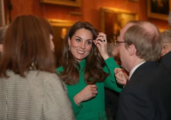 The Duchess of Cambridge was mingling with world dignitaries yesterday at a reception for NATO leaders at Buckingham Palace. For the event, Kate opted for a bright green look with a high neck and elegant puff sleeves. She added sparkle to the ensemble with a pair of dangling diamond earrings. Fans of the duchess believe she's wearing a bespoke look by Emilia Wickstead.