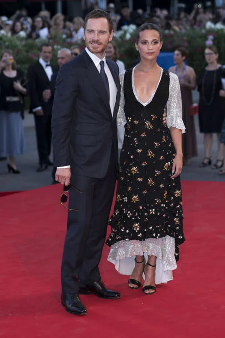 Michael Fassbender and Alicia Vikander in Louis Vuitton. Photo: Getty