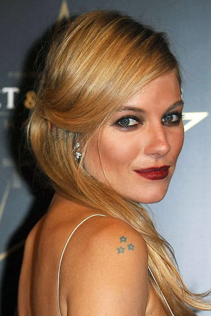 Miller has a trio of stars on her right shoulder, another single star on her hip, and a swallow in flight on her left wrist.