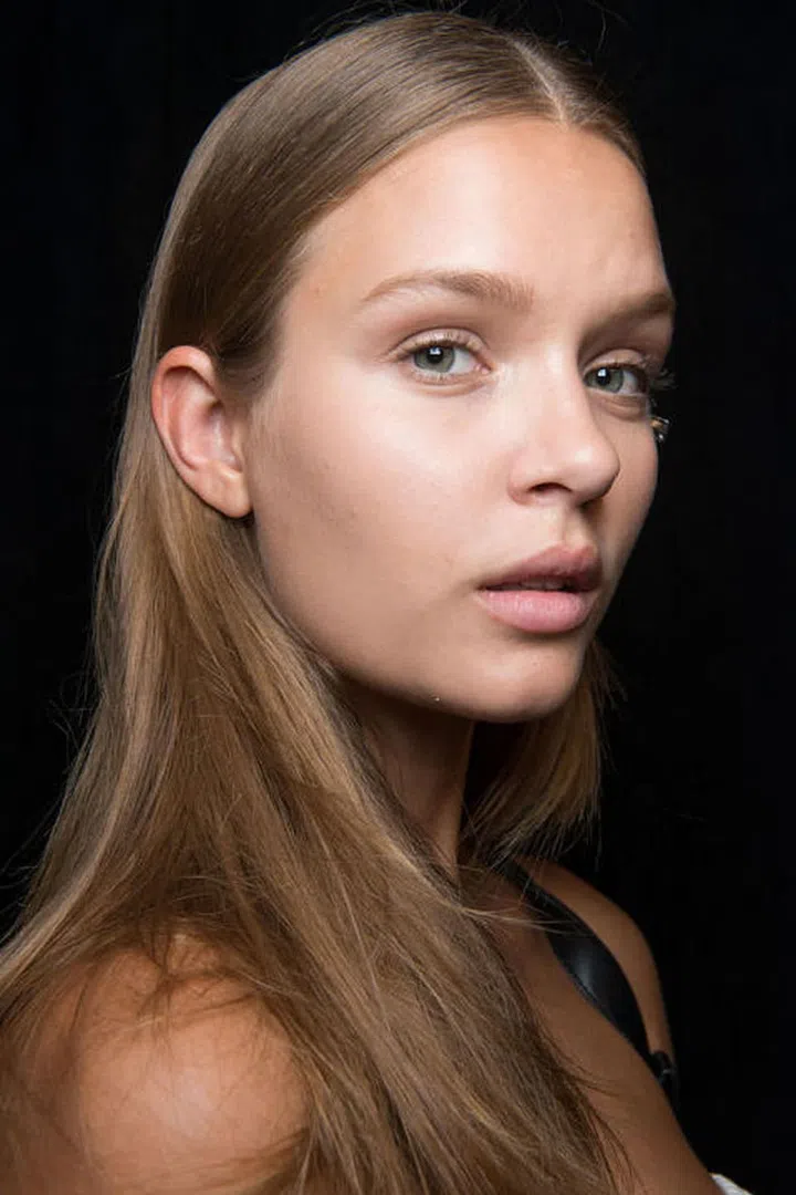 It was nearly 1,000 degrees backstage at Tommy Hilfiger, so the models' glow was half sweat, half moisturizer. 