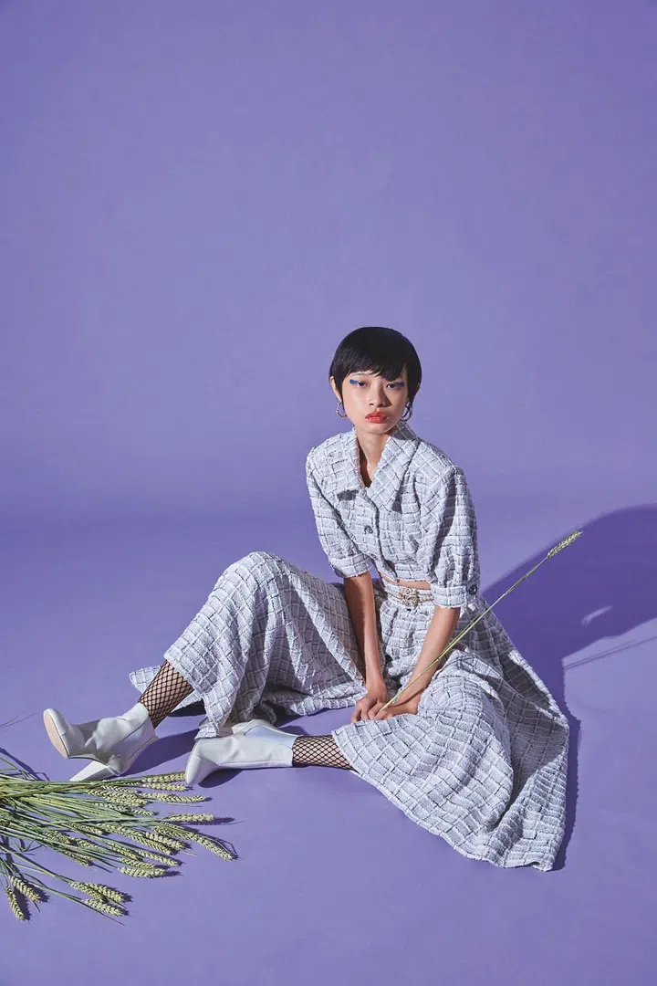 Top and matching culottes, earrings, belt, stockings, and booties, all from Chanel. (Photo: Vee Chin)