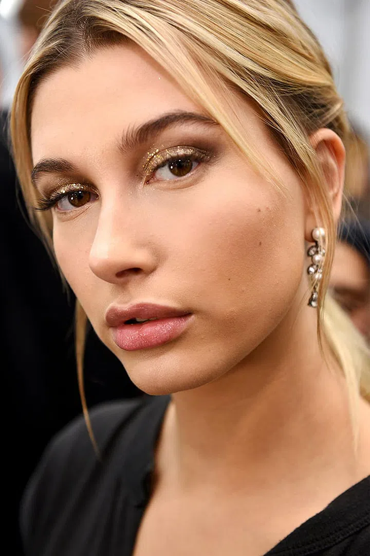 Good news: Glitter is definitely for grown-ups—if only because kids could never master the ways in which it showed up on the runways. Sparkle was at its most wearable at Tommy Hilfiger (left), where Pat McGrath topped off a taupe smoky eye with light sprinkling of gold, done in new ways—brow bone highlighter! tear drops!—at Giambattista Valli and Burberry and at its absolute fiercest at Anthony Vaccarello, where Tom Pecheux gave us the wild idea to cut apart our jewelry and affix it to our face. Why not?
Photo: Imaxtree
