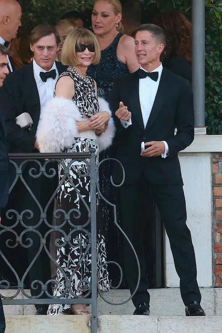 In a glam feathery shrug and her signature shades at George and Amal Clooney's wedding.  Photo: Rex Features
