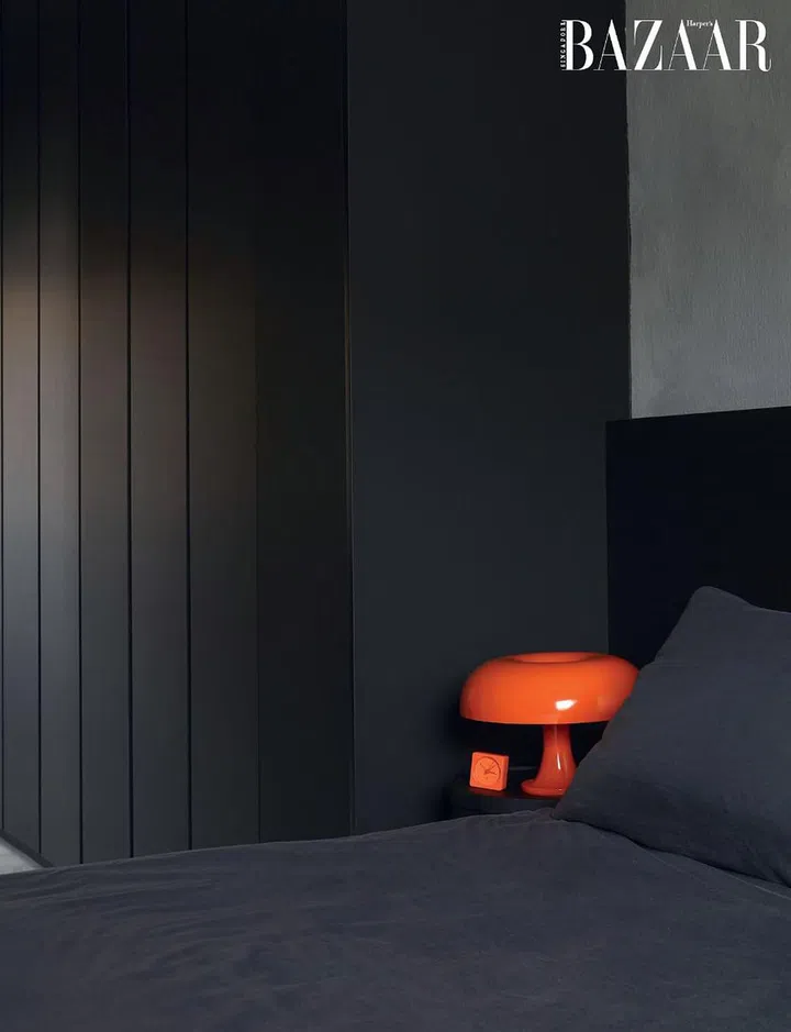 The master bedroom, with a lamp from Artemide on her husband’s side of the Lago bed.