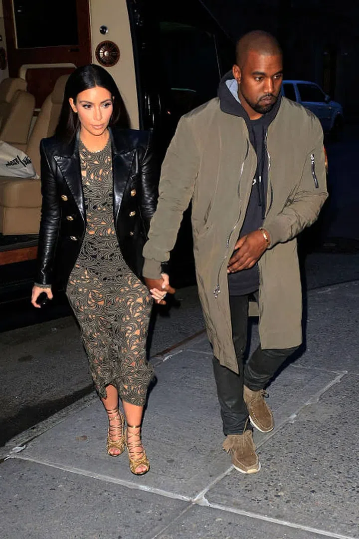  Kim matches her lacy Rachel Roy dress to Kanye's army-green anorak. Photo: Splash