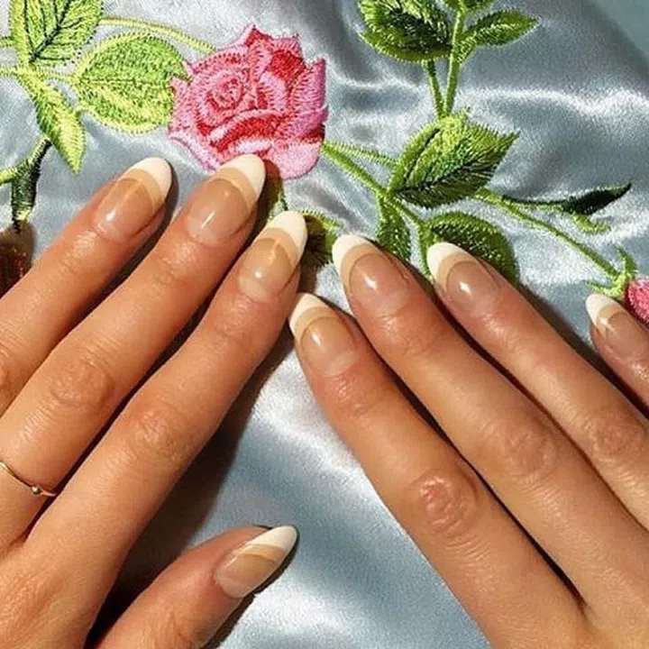 This look, worn by ELLE.com's own beauty guru Julie Schott, is an subtle way to update the french manicure. After your white tips are dry, underline it was a stripe of nude and finish it off with a clear topcoat. 
@naominailsnyc