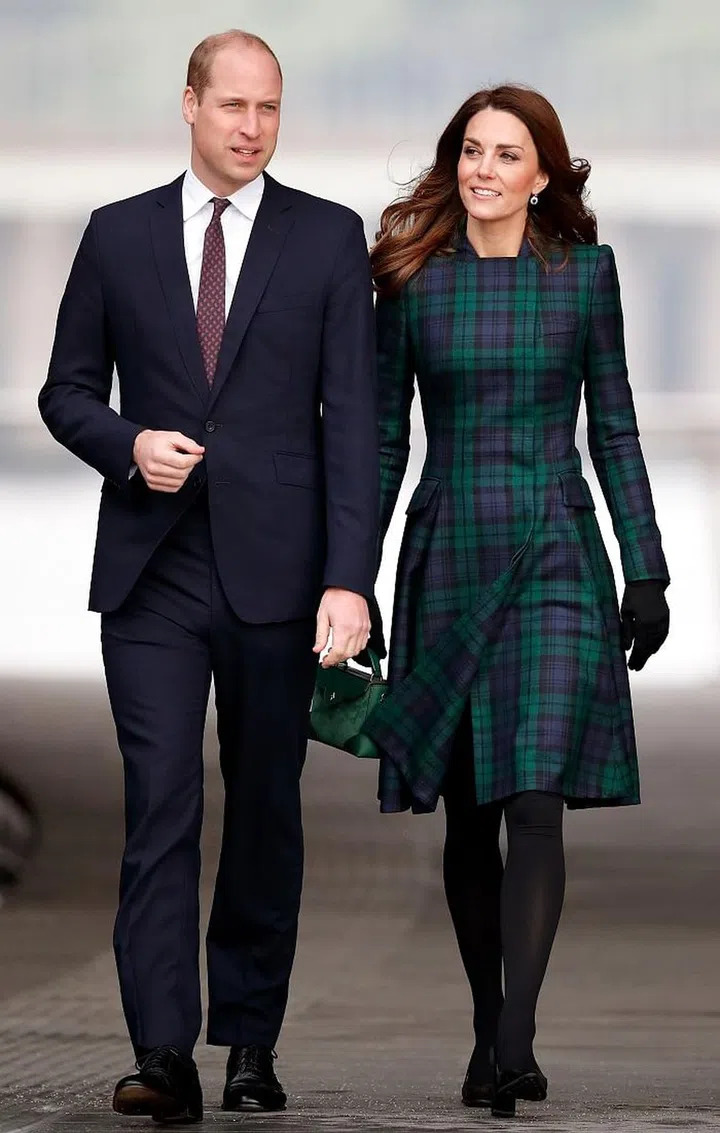The Duchess of Cambridge wore her Black Watch tartan coat by Alexander McQueen for her official trip to Dundee, Scotland. She accessorized with a green Manu Atelier handbag and black suede Tod’s pumps. 