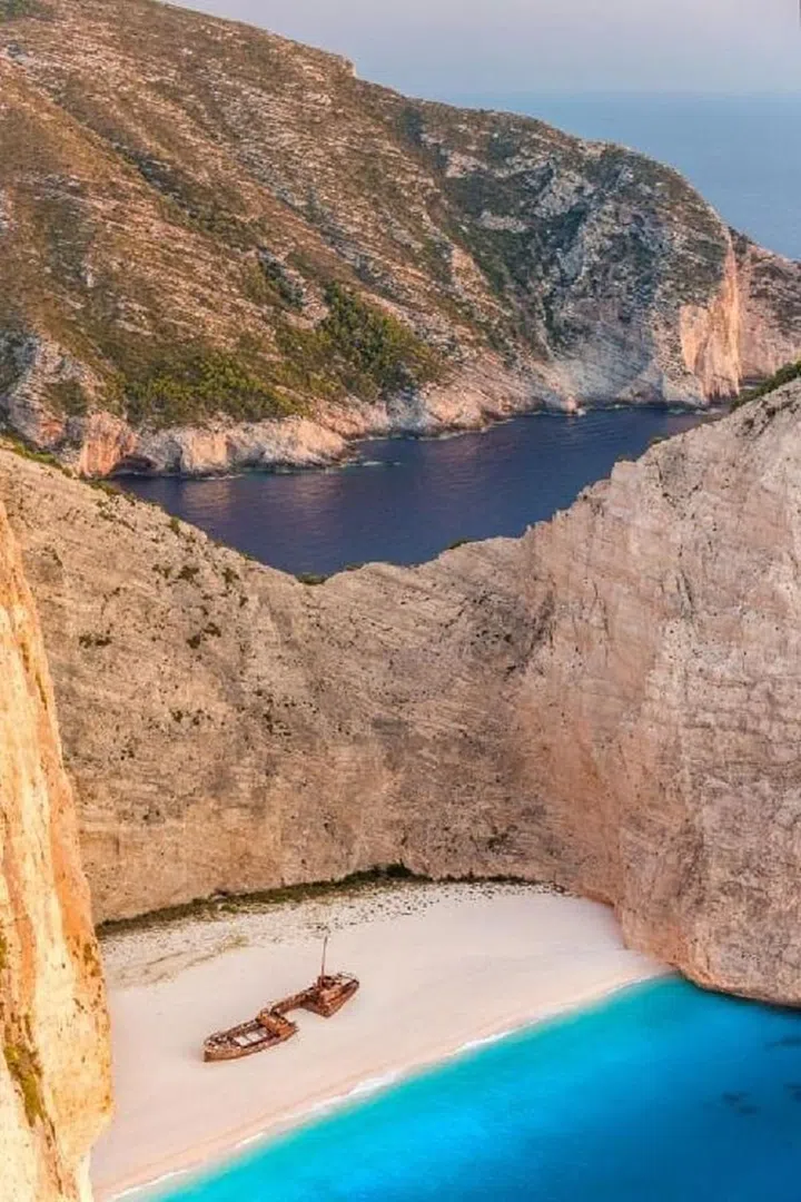 Often referred to as Smuggler's Cove, this sandy destination is lodged between two huge limestone cliffs. It's famous for having a three-decade-old shipwreck smack-dab in the middle of it that tourists can explore when they get tired of laying out. Photo: Getty  