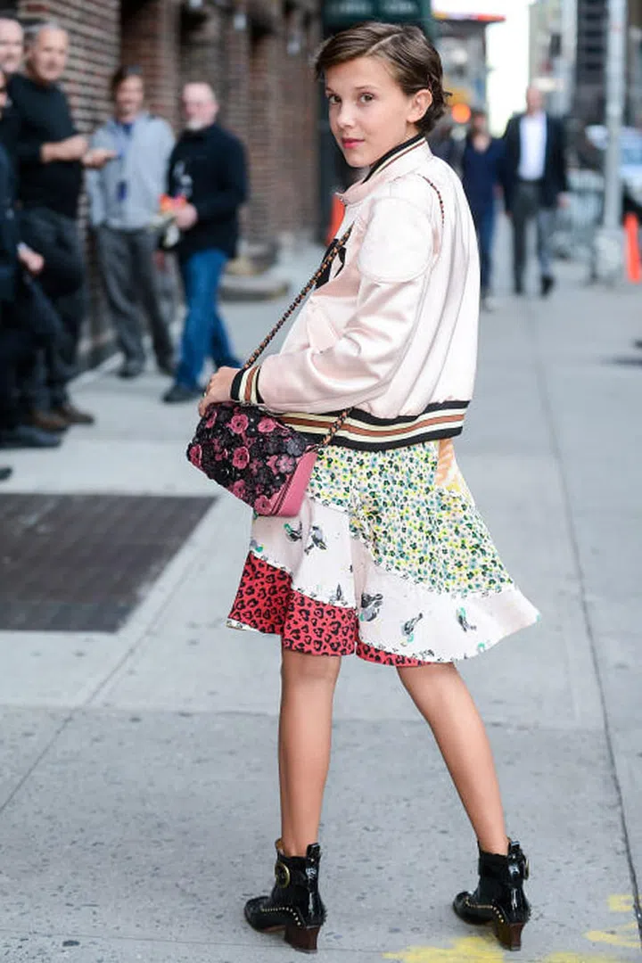 Age: 12
The tween better known as Eleven on Stranger Things is taking the fashion world by storm. She's already sat front row at NYFW, visited her new buddy Nicolas Ghesquière in Paris and graced two magazine covers before turning 13. As ahead as she is in the style game, she still stays young with prints, colors and a dash of quirk. 