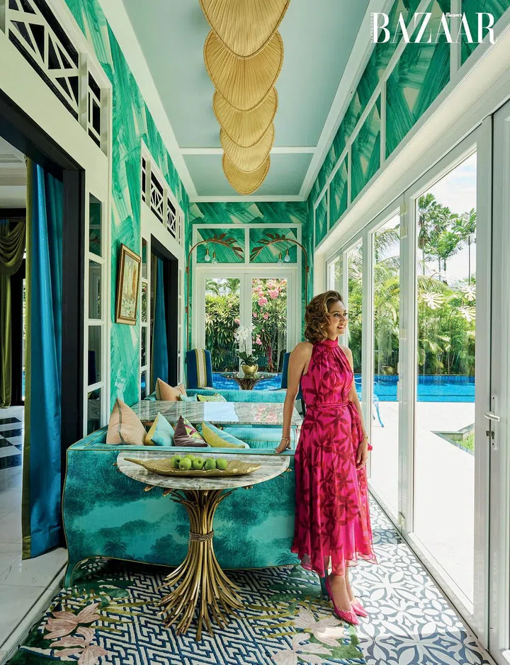 Award-winning interior designer, Nikki Hunt is a master of colour and pattern. Here, she is in the verandah of her home in her own Carolina Herrera dress and Dior pumps, accessorised with her own Cartier watch, Chanel bracelet and ring, and custom earrings.