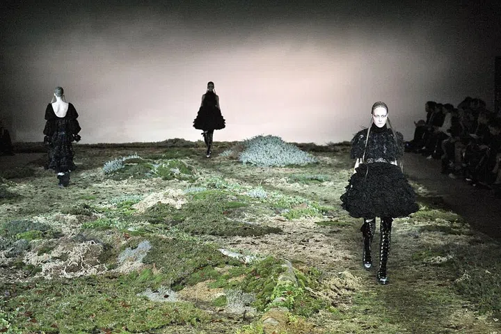 Alexander McQueen is known for unconventional, dramatic style, and this fashion show set was no exception. If your vibe is more "natural mystery" than, say, "playfully whimsical," embrace this ominous enchanted forest aesthetic with a dusky color palette accented with forest greens and mud browns. 
