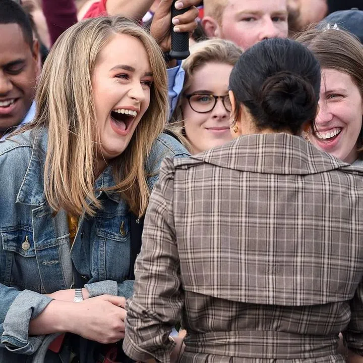 Meghan meets a fan that looks like Adele.

Meghan is wearing a Karen Walker Banks plaid trench, with her favorite Sarah Flint pumps. Photo: Getty 
