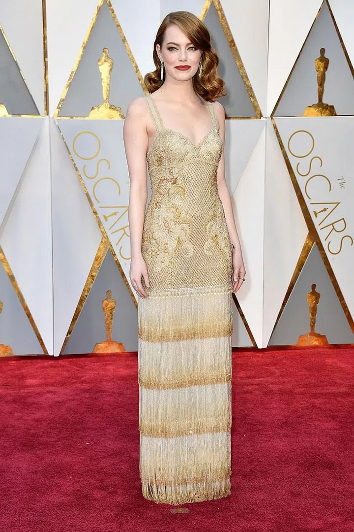 Emma Stone's gold and alabaster drop waist gown with a tiered fringe skirt was historic in multiple ways - it was not only the gown she wore for her first Oscar win, but was also likely one (if not the last) of Riccardo Tisci's red carpet gowns for Givenchy before he takes on his new role at Versace. While this look was flawless on Stone for her career's biggest night to date, it would also be ideal for the aisle if you added a simple veil.