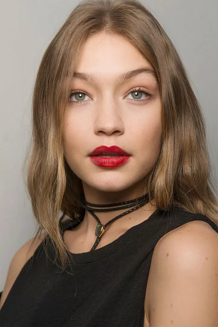 The Look: Youthful Beauty
How-To: "I want the lipstick to feel quite young, not too lady," said makeup artist Val Garland backstage at the Giambattista Valli show, where a handful of models walked with a pop of red lipstick. The flawless matte skin and blurry lipstick was meant to evoke the essence of youth. Picture it as the Valli woman looking back at an idealised version of her younger self. "It's about the most perfect, velvet, flawless, matte skin," said Garland. After prepping the skin, she used a combination of soft foundation powders to give skin a seamless matte finish that was nearly undetectable to the eye. She then applied a liquid matte red lipstick before blurring out the edges with a fluffy brush for a less proper finish.