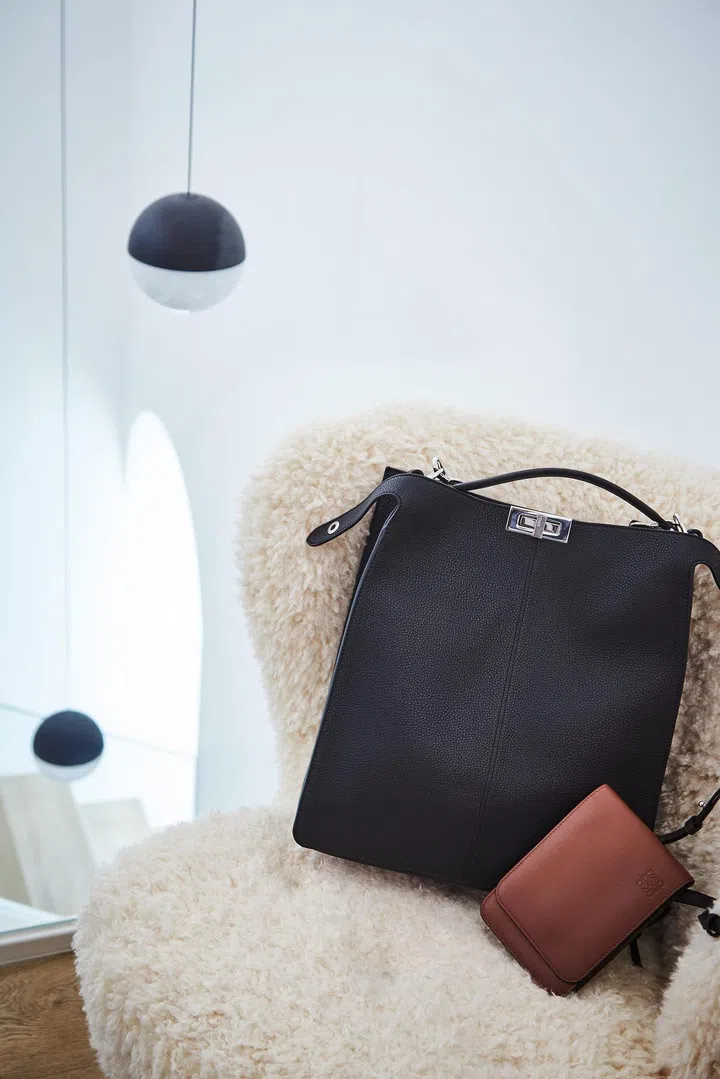 Wong’s Fendi tote and Loewe pouch perched on a chair in his mezzanine‑level recreation room. Photo: Veronica Tay.