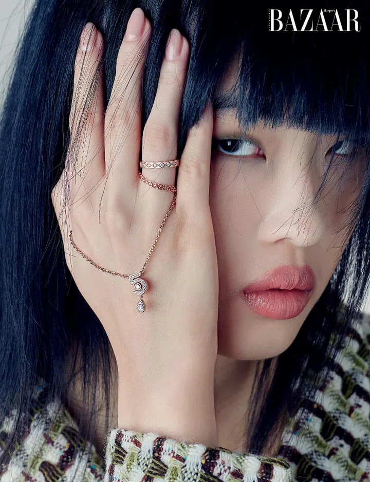 Beige gold and diamond Coco Crush mini ring; Beige gold and diamond Eternal N°5 necklace, Chanel. Jacket, Chanel.