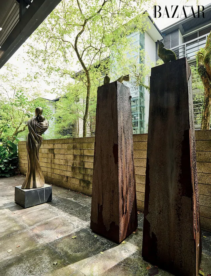Displayed on pedestals in the courtyard are sculptures of a mother and child, dove and dog.
