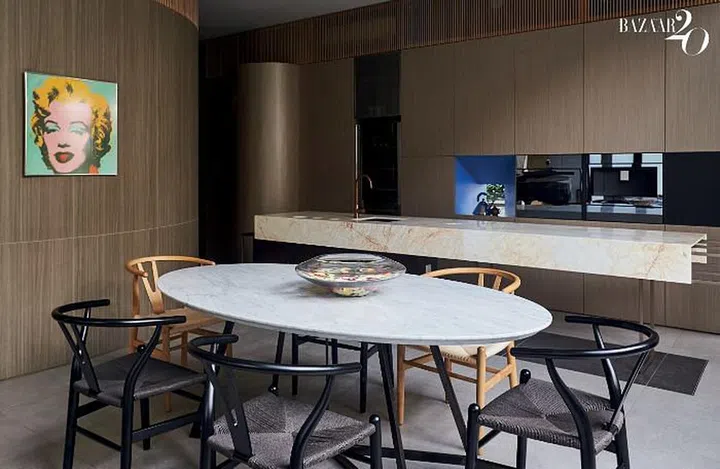 The dining area with a white marble-top table surrounded by Carl Hansen Wishbone chairs.

Photo: Phyllicia Wang
