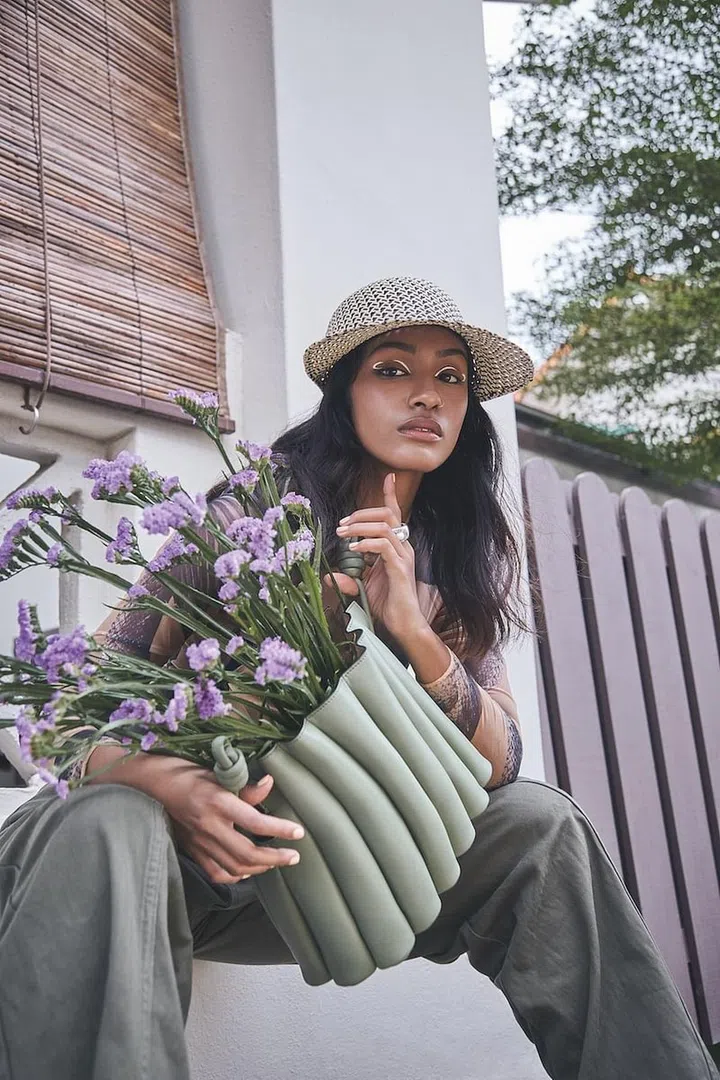 Bag, Loewe. Top, Burberry. Trousers, Chloé. Hat, Hermès. Ring, Bottega Veneta. (Photo: Phyllicia Wang)