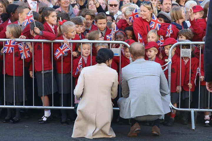 The pair crouched down to chat to a group of school children.