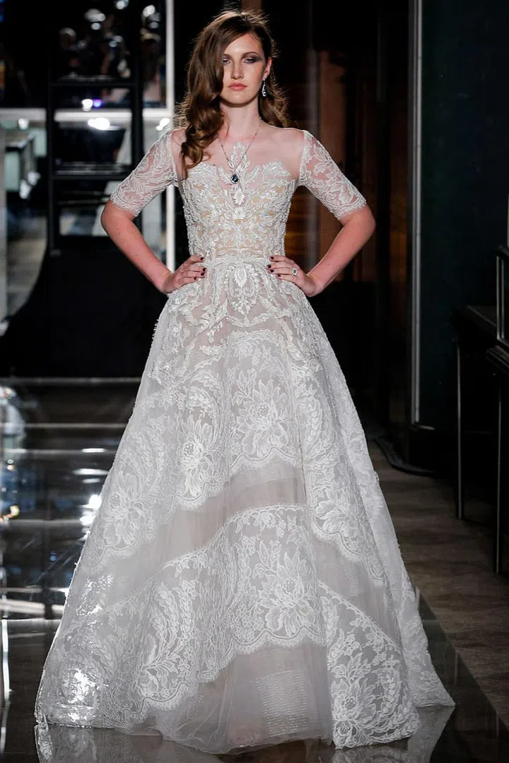 While all-over lace paired with a full skirt may seem overly formal, a natural landscape softens details like feminine fabrications, which can skew dramatic or delicate depending on the setting. Reem Acra "Majestic" gown, reemacra.com. Photo: Getty 