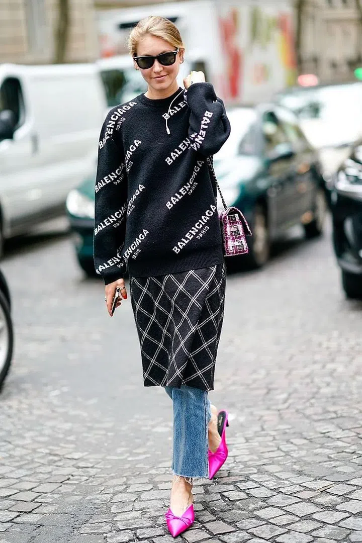 While it's much less daunting to wear long floaty frocks over your jeans, there's no reason why you can't make something shorter work too. This boxy mid-length skirt brings these straight-leg jeans to life. Photo: Getty
