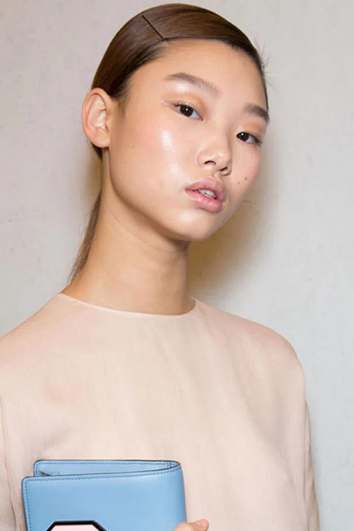 At Prada, the beauty look was all about raw and glossy skin.