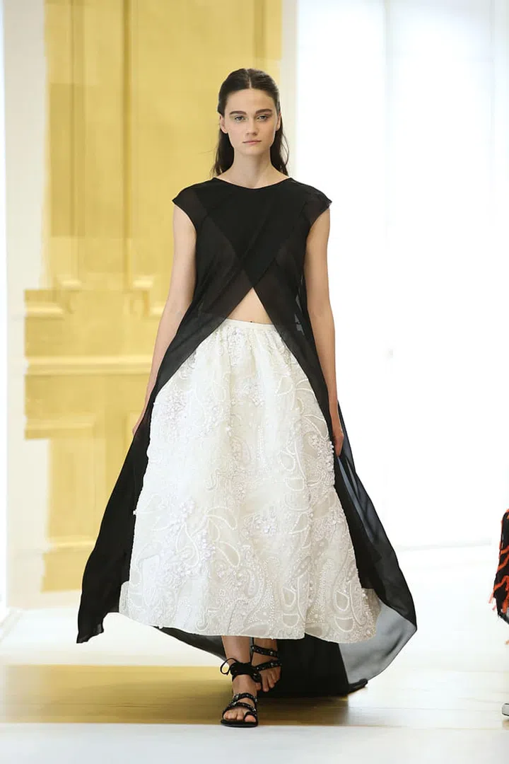 Two-piece dress in black silk georgette with ecru taffeta pleated skirt with white sequin embroidery.Photo: Dior
