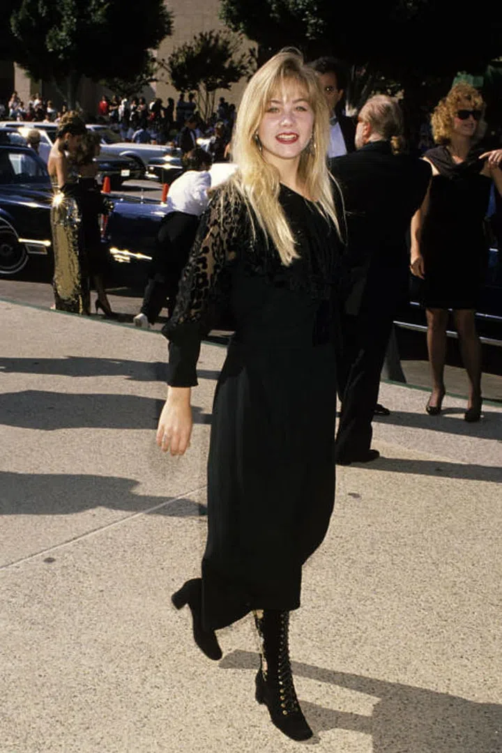 Applegate wore all-black and big bangs to the Emmy Awards in 1989.