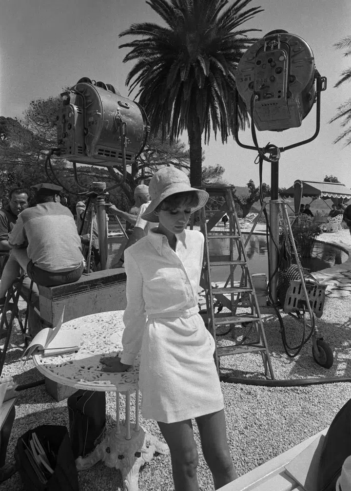 Showing off her fondness for hats, all-white and mini skirts.