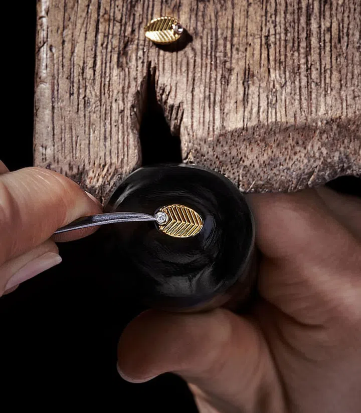 Rendered in solid yellow gold and studded with diamonds, the Grain de Café creations jingle and shimmer with the slightest movement, all while dazzling in the light. Photo: Cartier