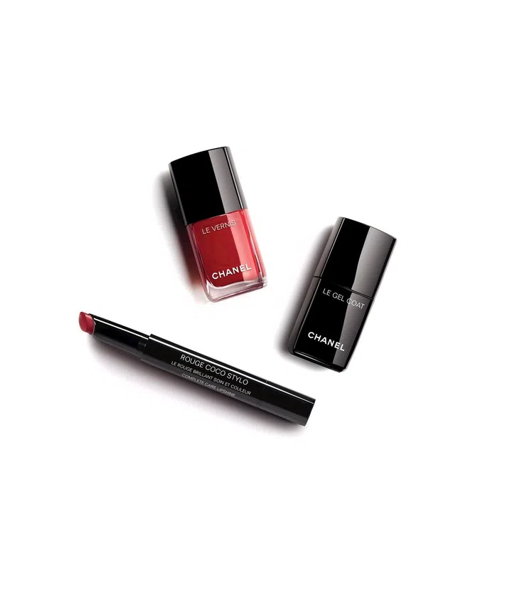 Match your nails and lips for an ultra-chic effect. Shown here: Rouge Coco Stylo in 214 Message, $49; Le Vernis is 500 Rouge Essentiel, $39; Le Gel Coat, $39. 