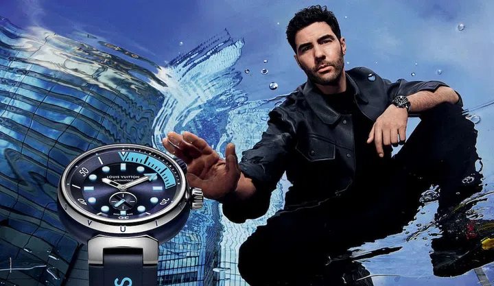 French actor Tahar Rahim wears gradients of blue across his wrist with the Skyline Blue colourway. (Photo: Mario Sorrenti/Louis Vuitton)
