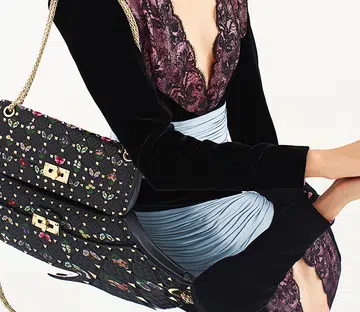 model poses with the new butterfly embroidered valentino garavani rockstud spike